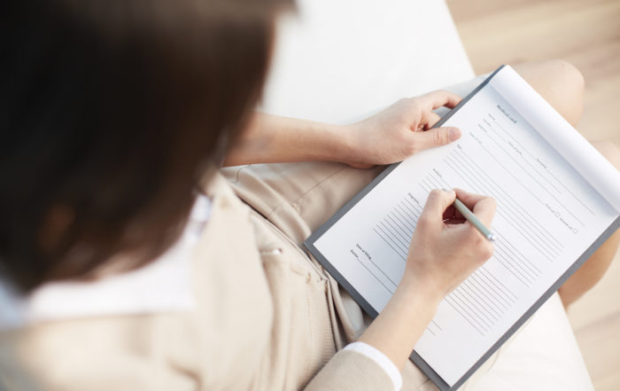 A social worker during a counselling session taking notes