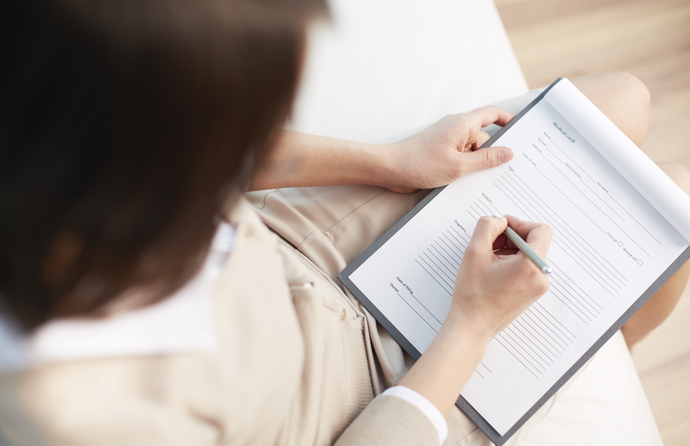 A social worker during a counselling session taking notes